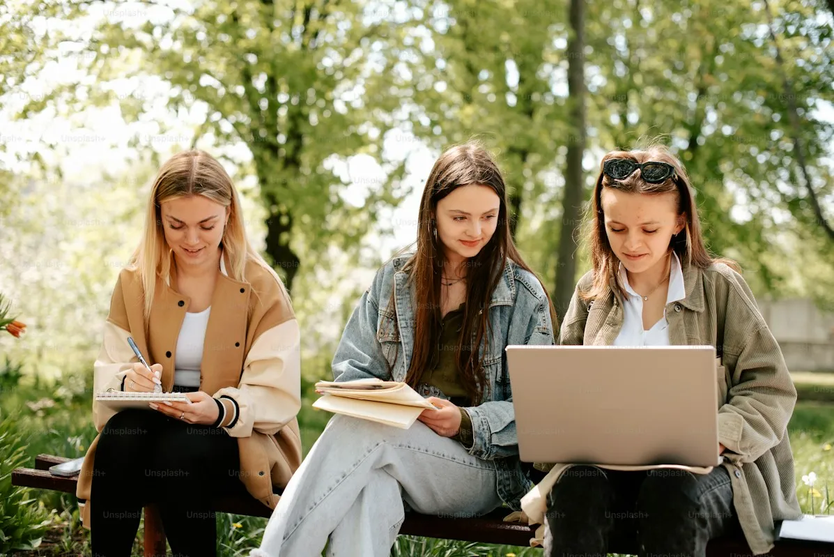 Students studying outdoors on campus grounds
