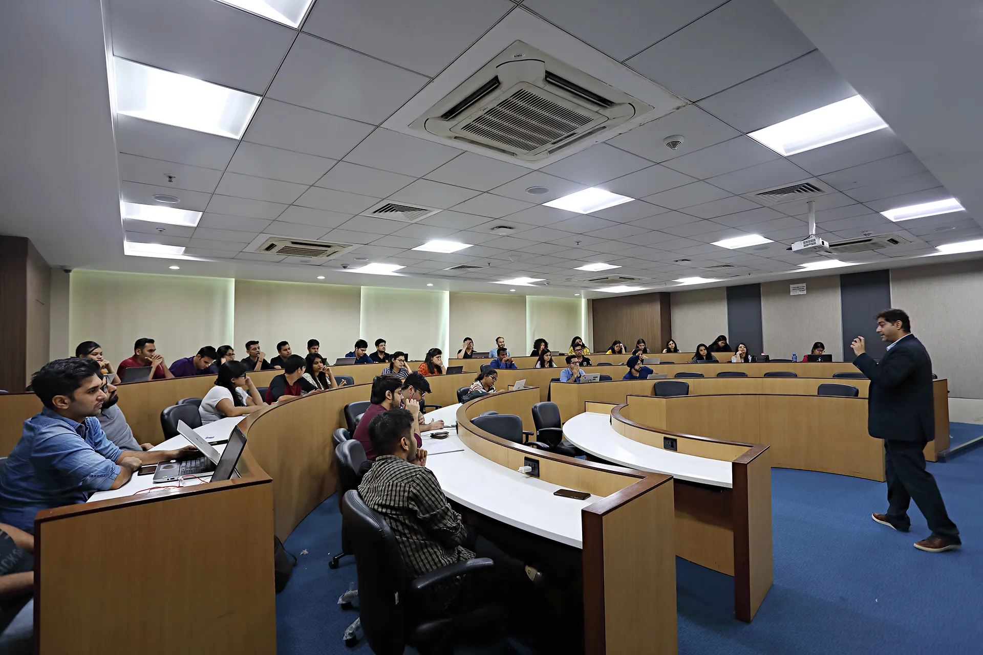 Modern interactive amphitheater classroom with students and faculty